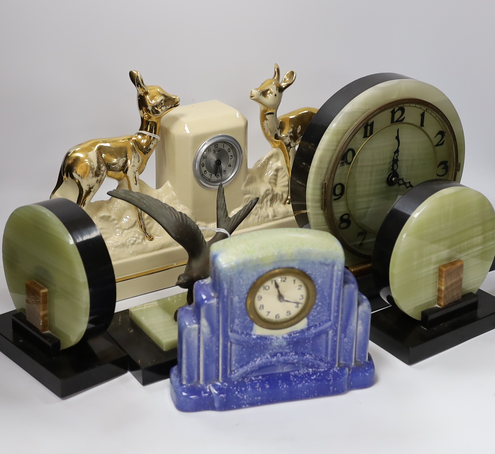 A French Art Deco green onyx clock garniture with Blue bird spelter mount, clock 46cm wide